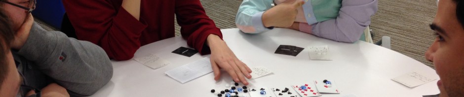 People playing a board game with index cards
